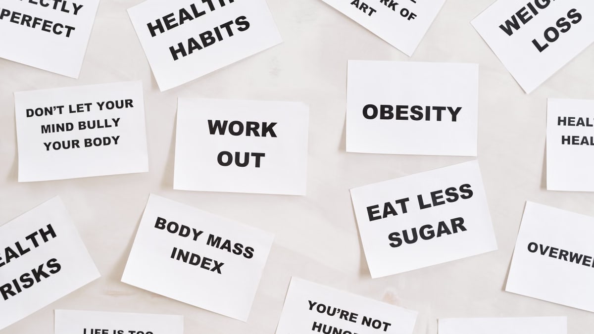 Collection of motivational quotes promoting health and wellness on paper cards.